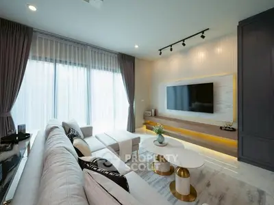 Luxurious modern living room with elegant decor and large TV setup