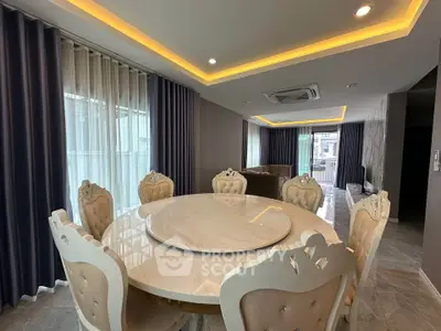 Luxurious dining area with elegant round table and plush chairs in modern apartment
