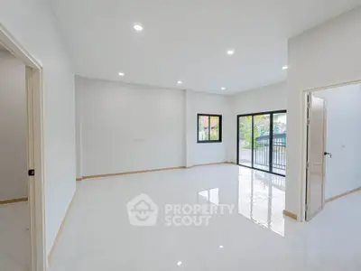 Spacious modern living room with large windows and glossy tiled floors