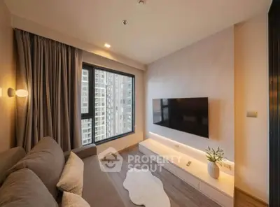 Modern living room with large window and wall-mounted TV in high-rise apartment