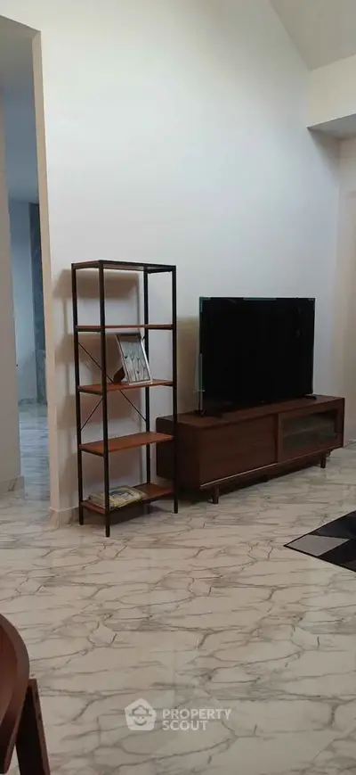 Modern living room with sleek TV stand and marble flooring