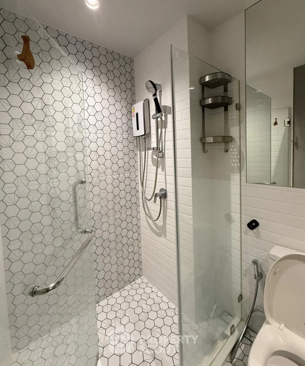 Modern bathroom with geometric tiles and glass shower enclosure