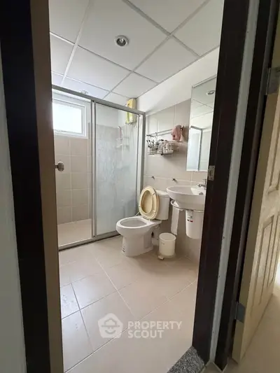 Modern bathroom with glass shower and sleek fixtures in a contemporary home.
