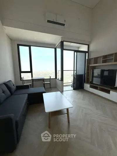 Modern living room with large windows and city view