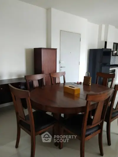 Spacious dining area with elegant wooden furniture and modern appliances.