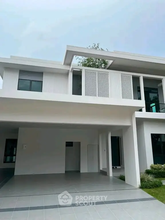 Modern two-story house with sleek architectural design and spacious garage.