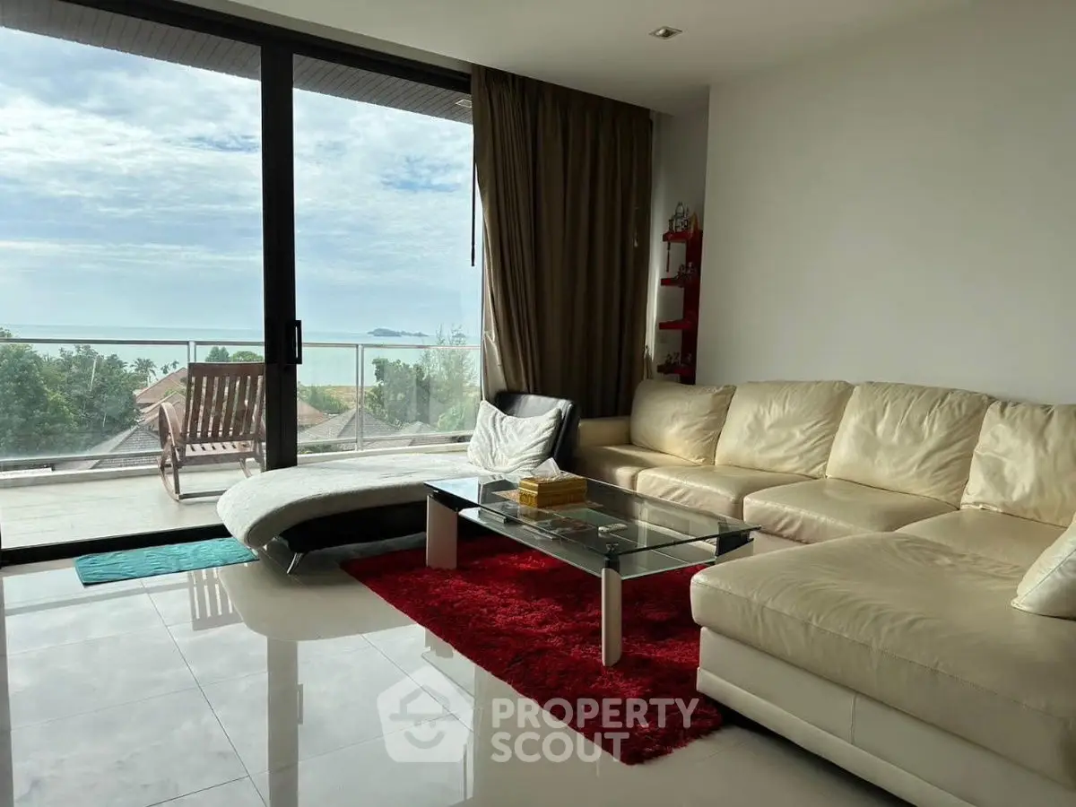 Luxurious living room with stunning ocean view and modern furnishings.