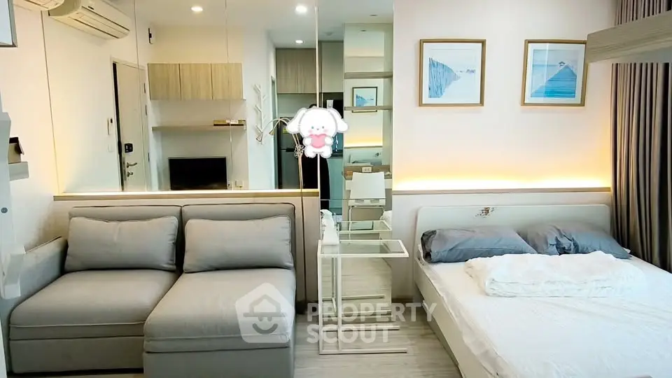 Modern studio apartment with cozy living area and stylish decor