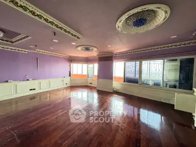 Spacious living room with elegant ceiling design and polished wooden floors