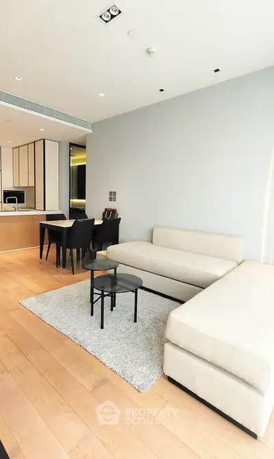 Modern living room with sleek furniture and open kitchen layout