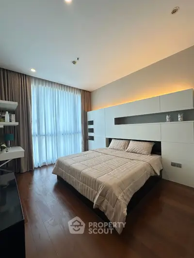 Modern bedroom with elegant design and large window for natural light