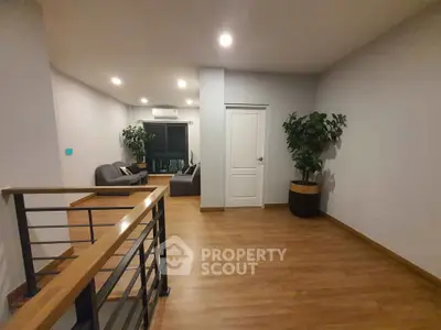 Spacious modern living room with wooden flooring and stylish furniture
