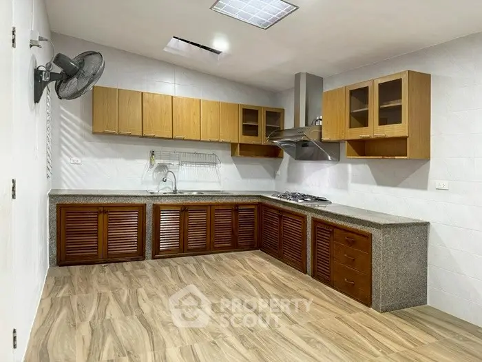 Spacious kitchen with wooden cabinets and modern appliances