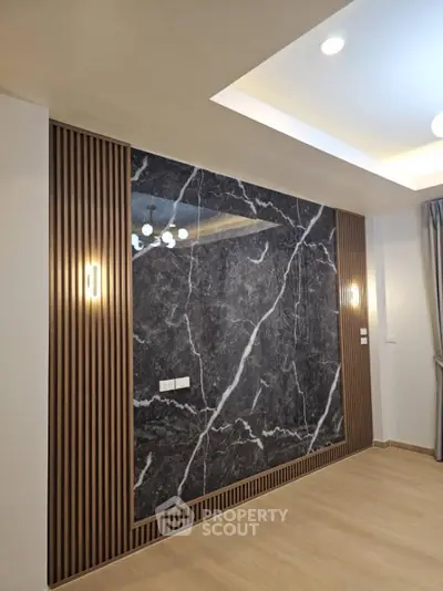 Modern interior with marble accent wall and elegant lighting