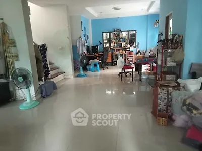 Spacious living room with tiled flooring and modern decor, ideal for family gatherings.