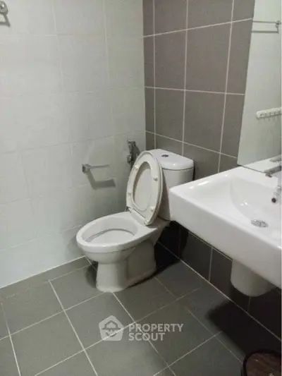 Modern bathroom with sleek tiles and contemporary fixtures.