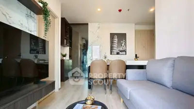 Modern living room with stylish decor and open layout, featuring a cozy sofa and elegant dining area.