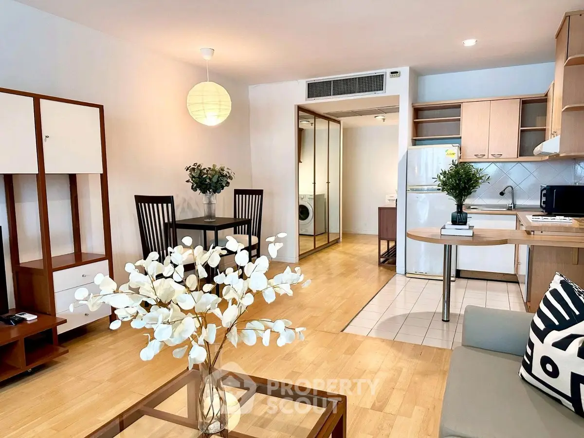 Modern open-plan living room with stylish decor and kitchen area