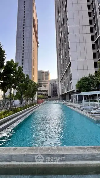 Luxurious high-rise residential complex with stunning outdoor pool and modern architecture.