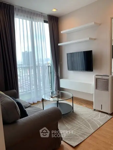 Modern living room with city view, cozy sofa, and wall-mounted TV in a stylish apartment.