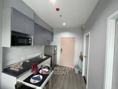 Modern kitchen with sleek cabinets and dining setup in a stylish apartment