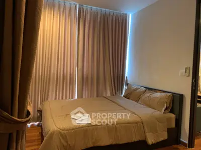 Cozy bedroom with elegant curtains and warm lighting, perfect for relaxation and comfort.