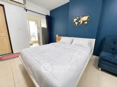 Modern bedroom with blue accent wall and stylish decor
