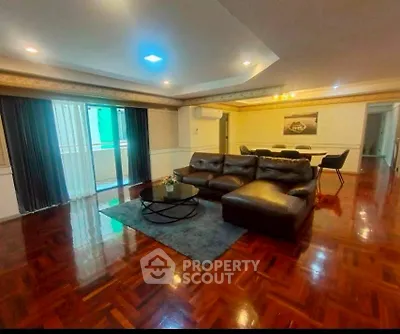 Spacious living room with elegant hardwood floors and modern furniture, perfect for entertaining guests.