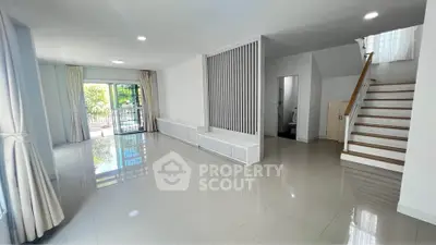 Spacious modern living room with glossy floors and natural light