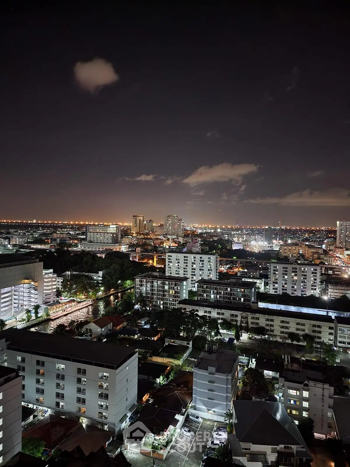 Stunning cityscape view from high-rise building at night with vibrant city lights.