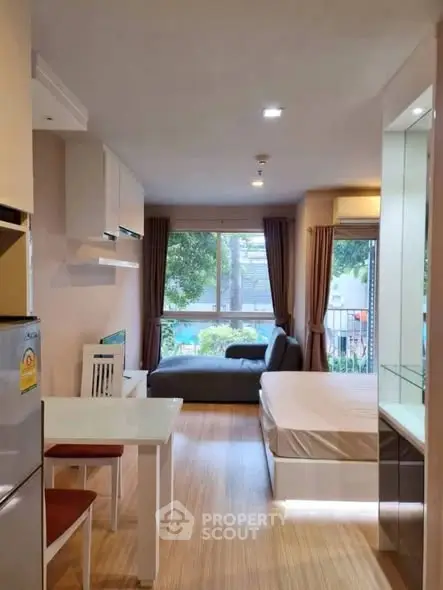 Modern studio apartment with open layout and large window view