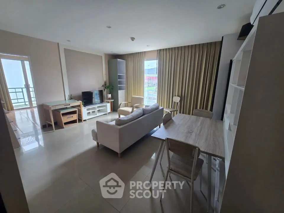 Spacious modern living room with large windows and elegant furnishings