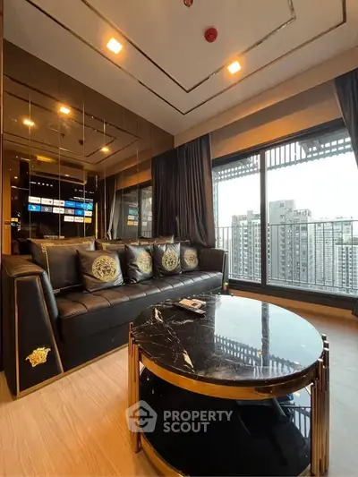 Luxurious living room with elegant black leather sofa and stunning city view from large window.