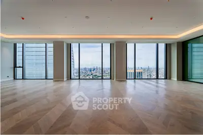 Luxurious high-rise apartment with stunning cityscape views and elegant wooden flooring.
