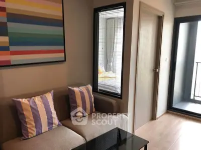 Cozy living room with modern decor and balcony access