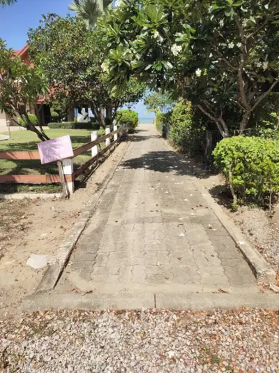 Charming garden pathway leading to a serene beachfront view