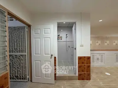 Spacious bathroom with modern shower and elegant tile design