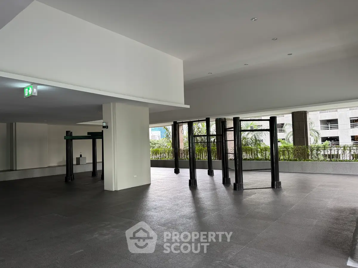 Spacious modern building interior with large windows and open layout, ideal for versatile use.