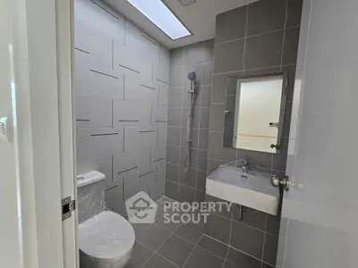 Modern bathroom with sleek gray tiles and minimalist fixtures