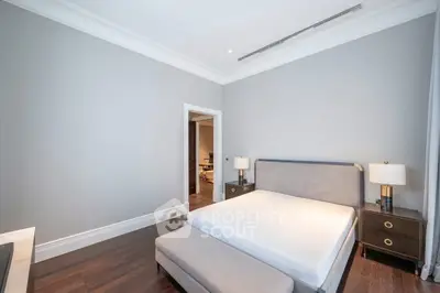 Spacious modern bedroom with elegant furnishings and hardwood floors