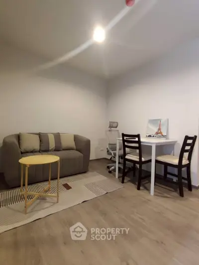 Cozy living room with modern furniture and study area, perfect for urban living.