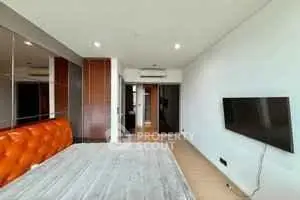 Modern bedroom with wall-mounted TV and stylish decor