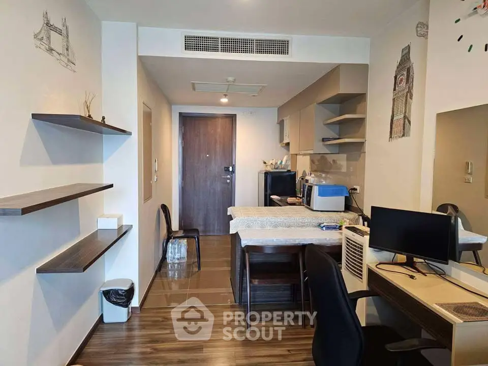 Modern apartment interior with open layout, featuring a cozy living area and stylish kitchen.
