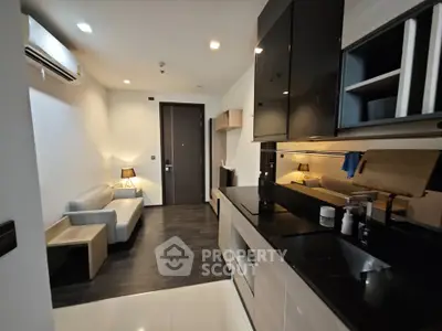 Modern studio apartment with sleek kitchen and cozy living area