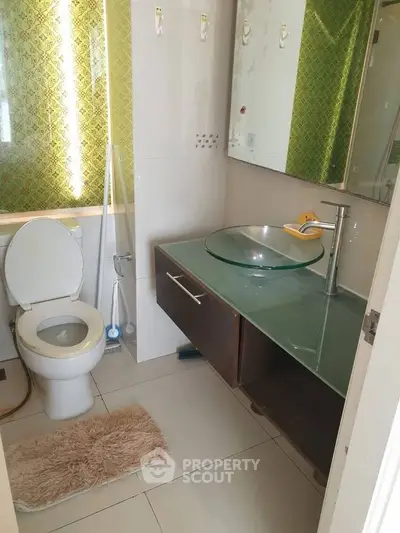 Modern bathroom with glass sink and stylish decor