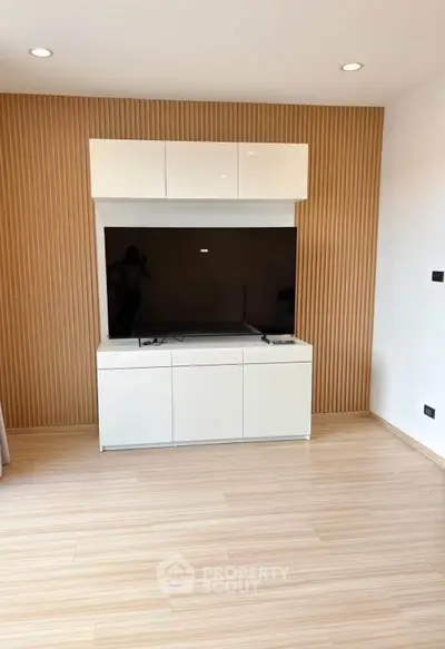 Modern living room with sleek TV unit and wooden accent wall