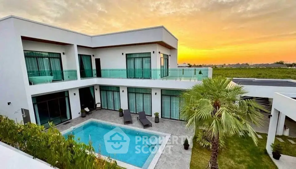 Luxurious modern villa with private pool and stunning sunset view, perfect for upscale living.