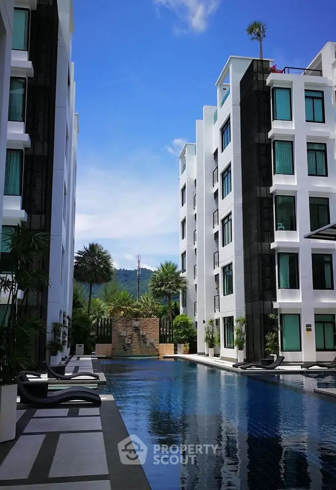 Luxurious modern apartment complex with stunning pool and mountain views.