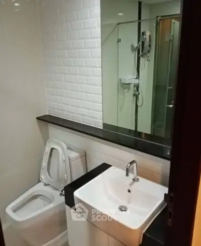 Modern bathroom with sleek fixtures and glass shower enclosure