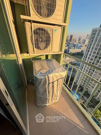 High-rise balcony with air conditioning units and city view